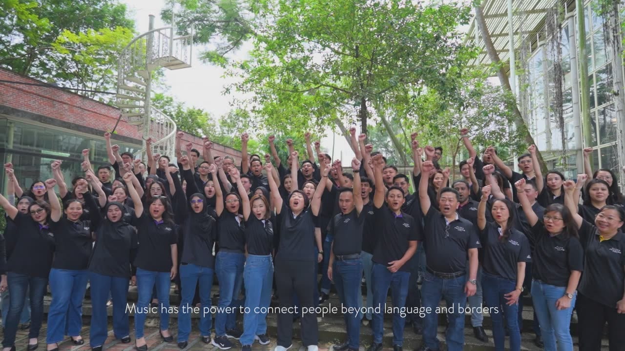 Singers celebrate with raised hands in the MCE 'Malaysia KL Story' film