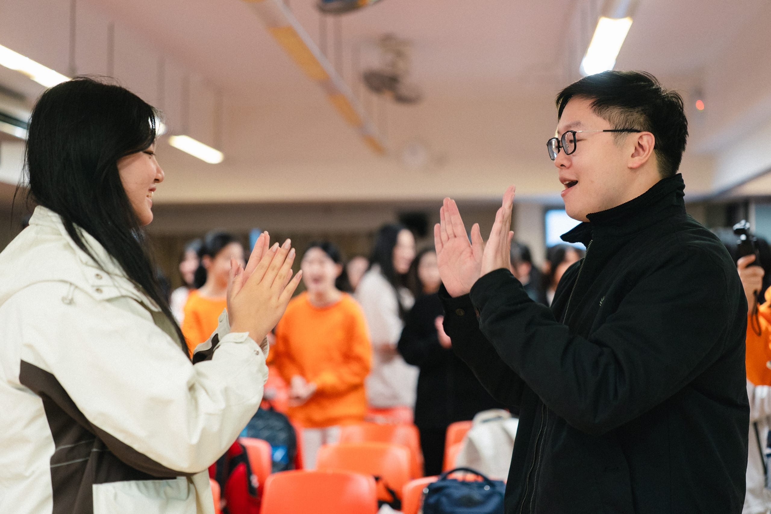 Teachers clapping along while observing an HKVC choral session