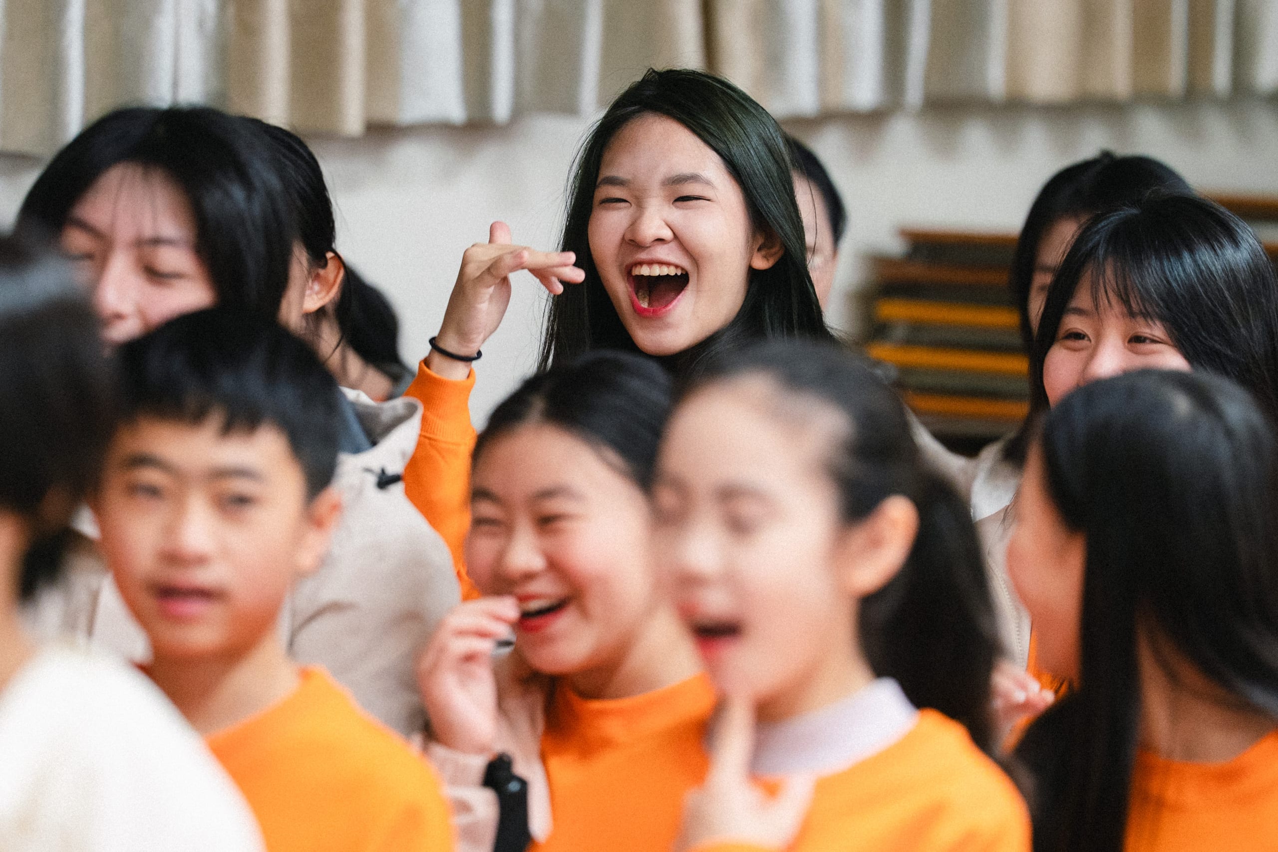 Students laughing joyfully at an HKVC school choral celebration